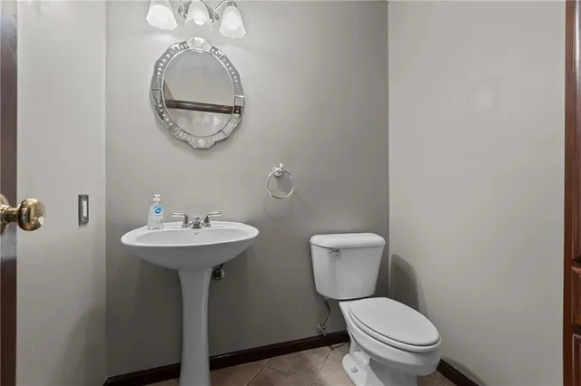 a view of a hallway with entryway and chandelier