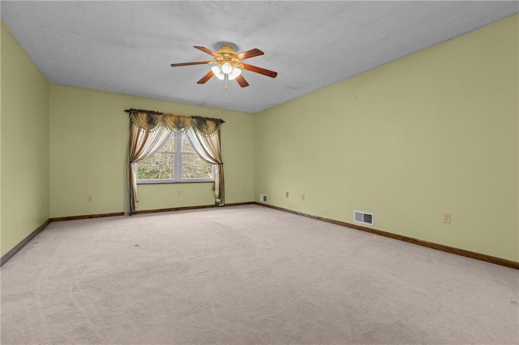 223 Balsinger Road Uniontown, PA 15401 - Photo 25 of 50 an empty room with windows and chandelier fan