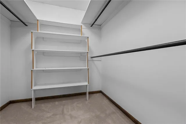 an empty room with closet and fan