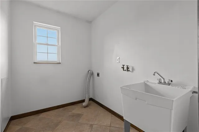 an empty room with closet and a chandelier fan