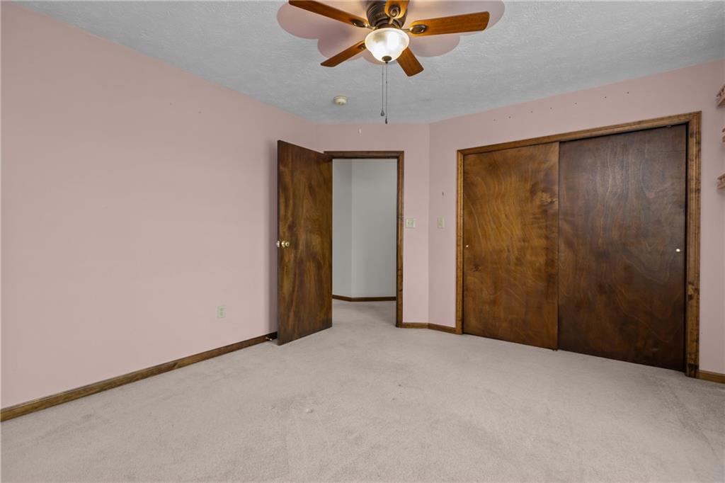 223 Balsinger Road Uniontown, PA 15401 - Photo 30 of 50 an empty room with closet and a chandelier fan