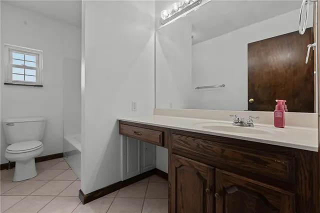 an empty room with chandelier fan