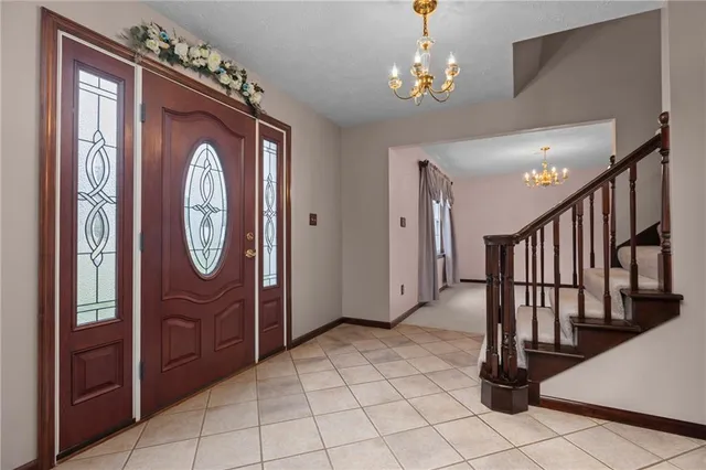 a view of an empty room with furniture and a window