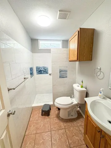 a bathroom with a sink toilet and shower