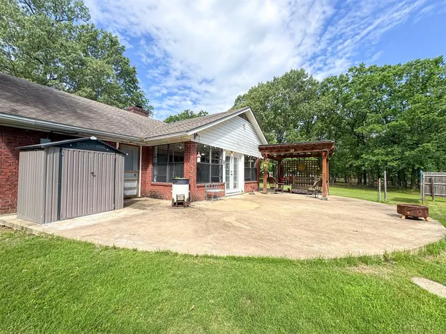 a view of a house with a yard and sitting area