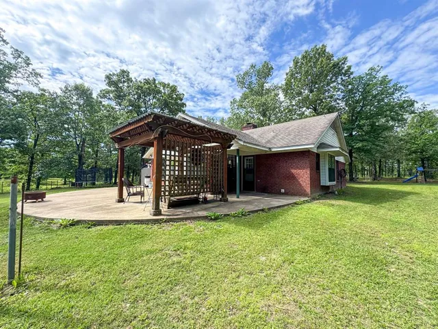 a view of a house with a yard and tree