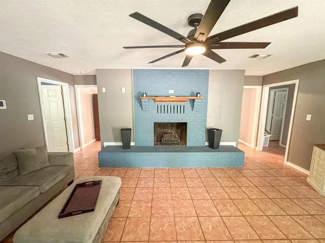 a living room with a couch and a ceiling fan