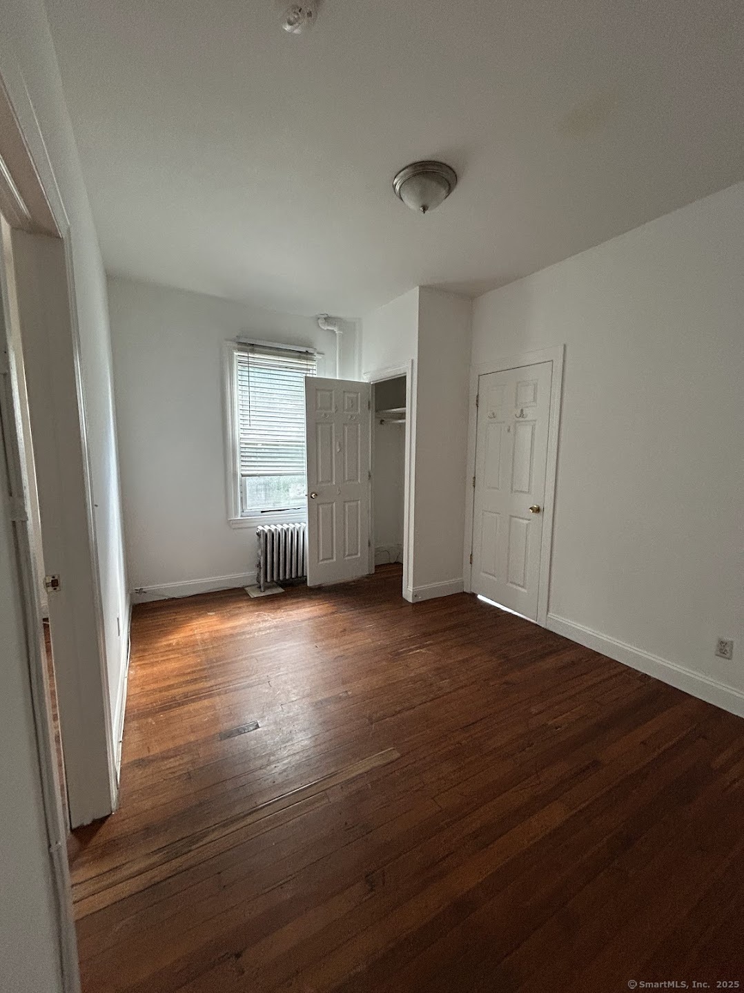14 Relay Place, Unit L2 Stamford, CT 06901 - Photo 3 of 15 an empty room with wooden floor and windows