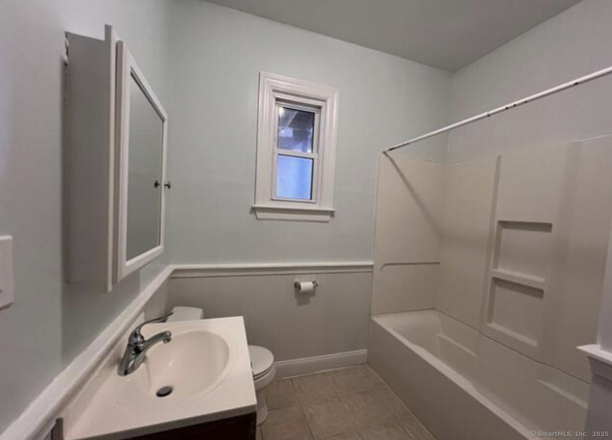 14 Relay Place, Unit L2 Stamford, CT 06901 - Photo 6 of 15 a bathroom with a sink a toilet and shower
