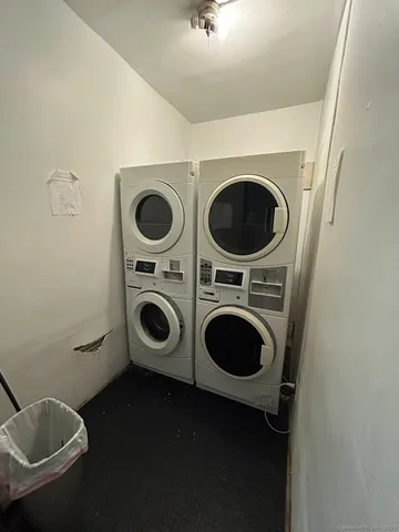 a utility room with dryer washer and a view of bedroom