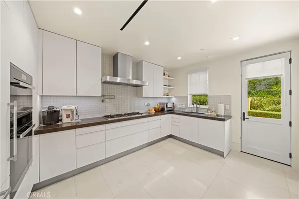 a view of a dining room with furniture a chandelier and wooden floor