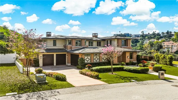 a front view of a house with a garden
