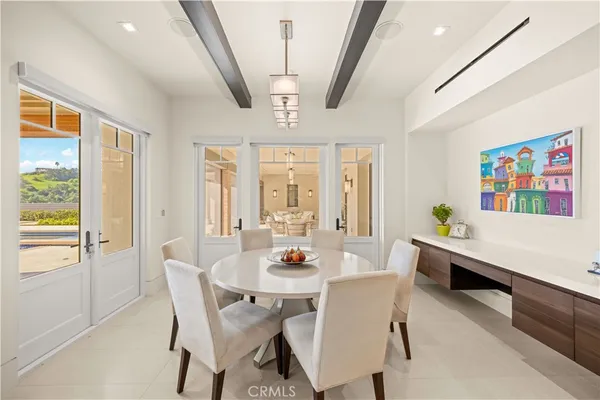 a view of a hallway with wooden floor and windows