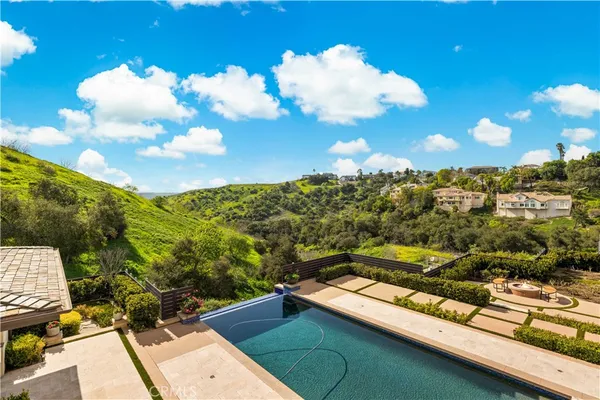a dining room with furniture and a floor to ceiling window