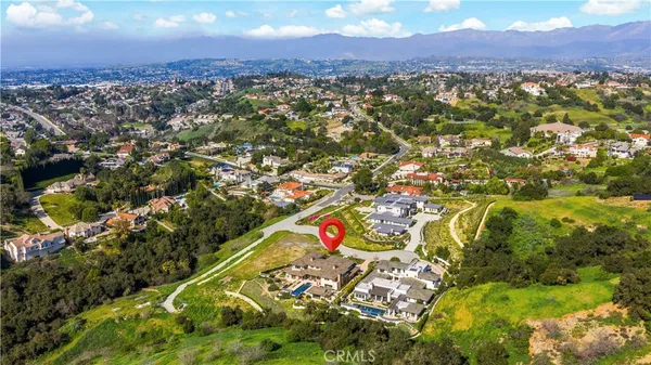 an aerial view of a house with a yard and lake view