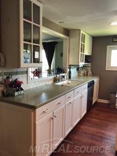 32010 Weber Road Richmond, MI 48062 - Photo 17 of 45 Talk about a country kitchen!!!! This one takes it to a whole new level. White cabinetry, 3 pantry's, coffee bar, snack bar, glass display cabinet.