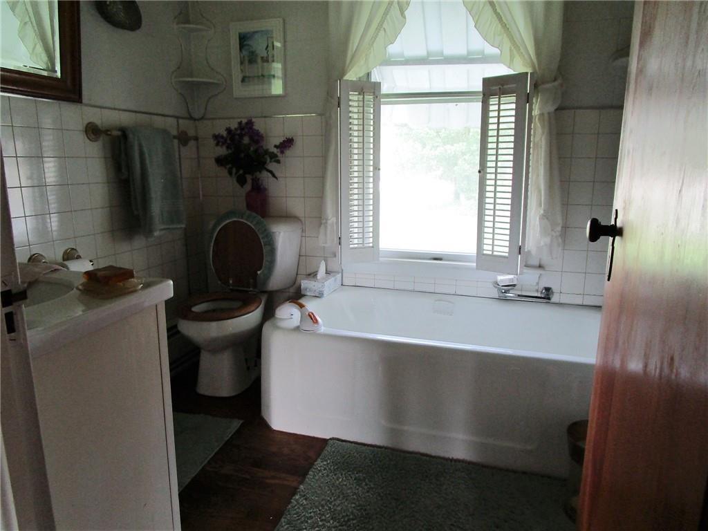 232 North Main Street Cambridge Springs, PA 16403 - Photo 16 of 23 a bath tub sitting in a bathroom next to a window