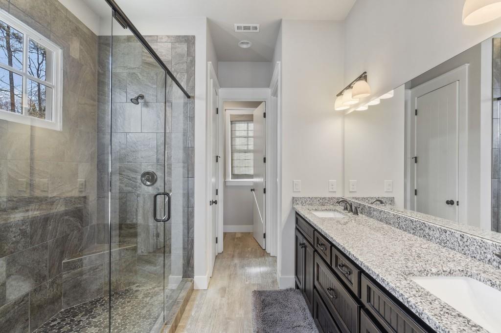 72 Buckeye Ridge Newnan, GA 30263 - Photo 21 of 80 a bathroom with a granite countertop double vanity sink and a mirror