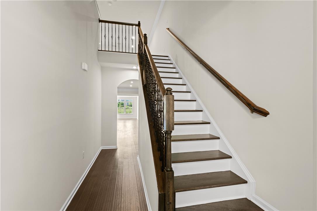 4758 Rafi Road Easton, PA 18045 - Photo 39 of 55 A grand staircase with rich wood treads and wrought iron balusters leads to an open second-story landing.