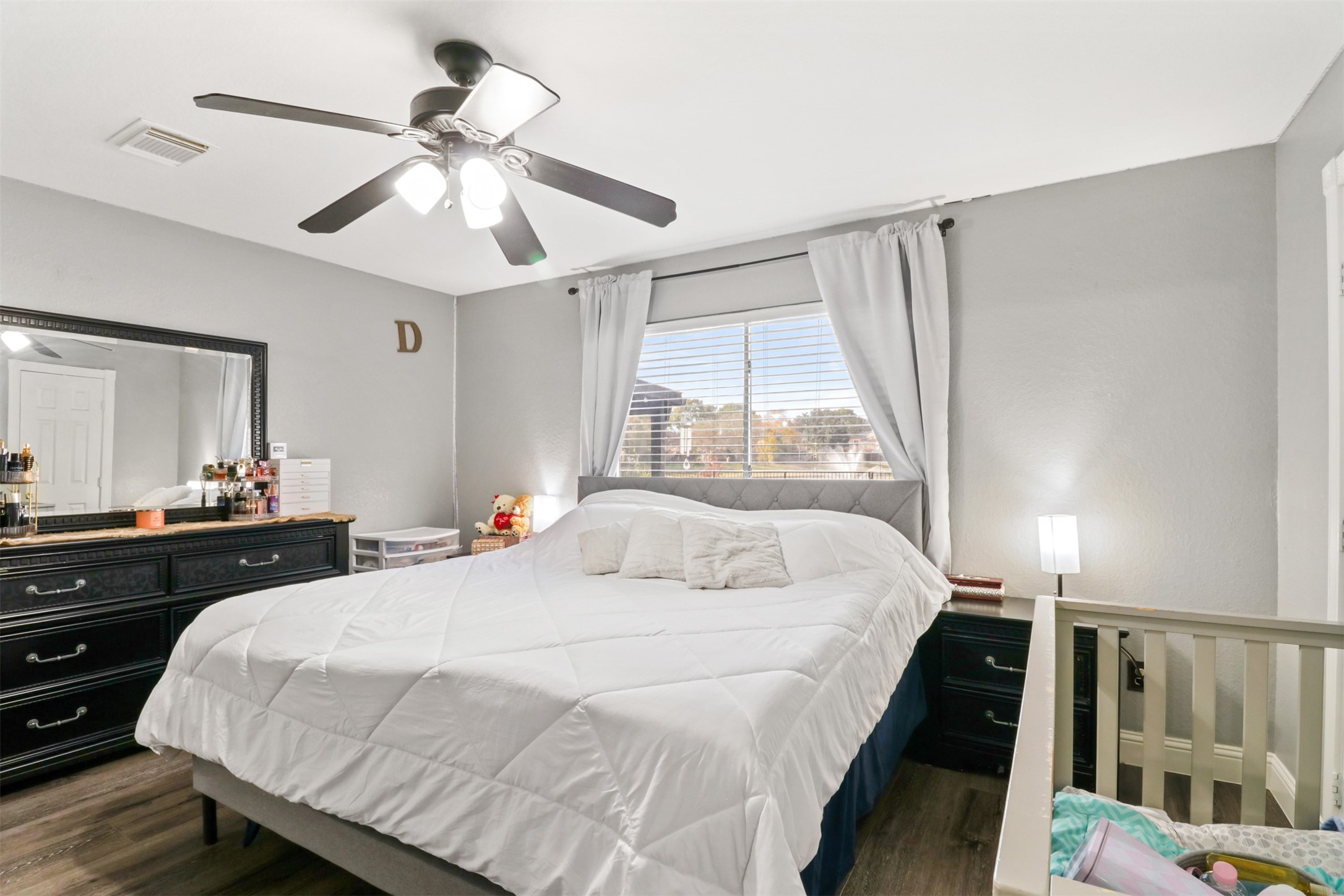 23027 Canal Road Richmond, TX 77406 - Photo 15 of 31 a bedroom with a bed and a chandelier