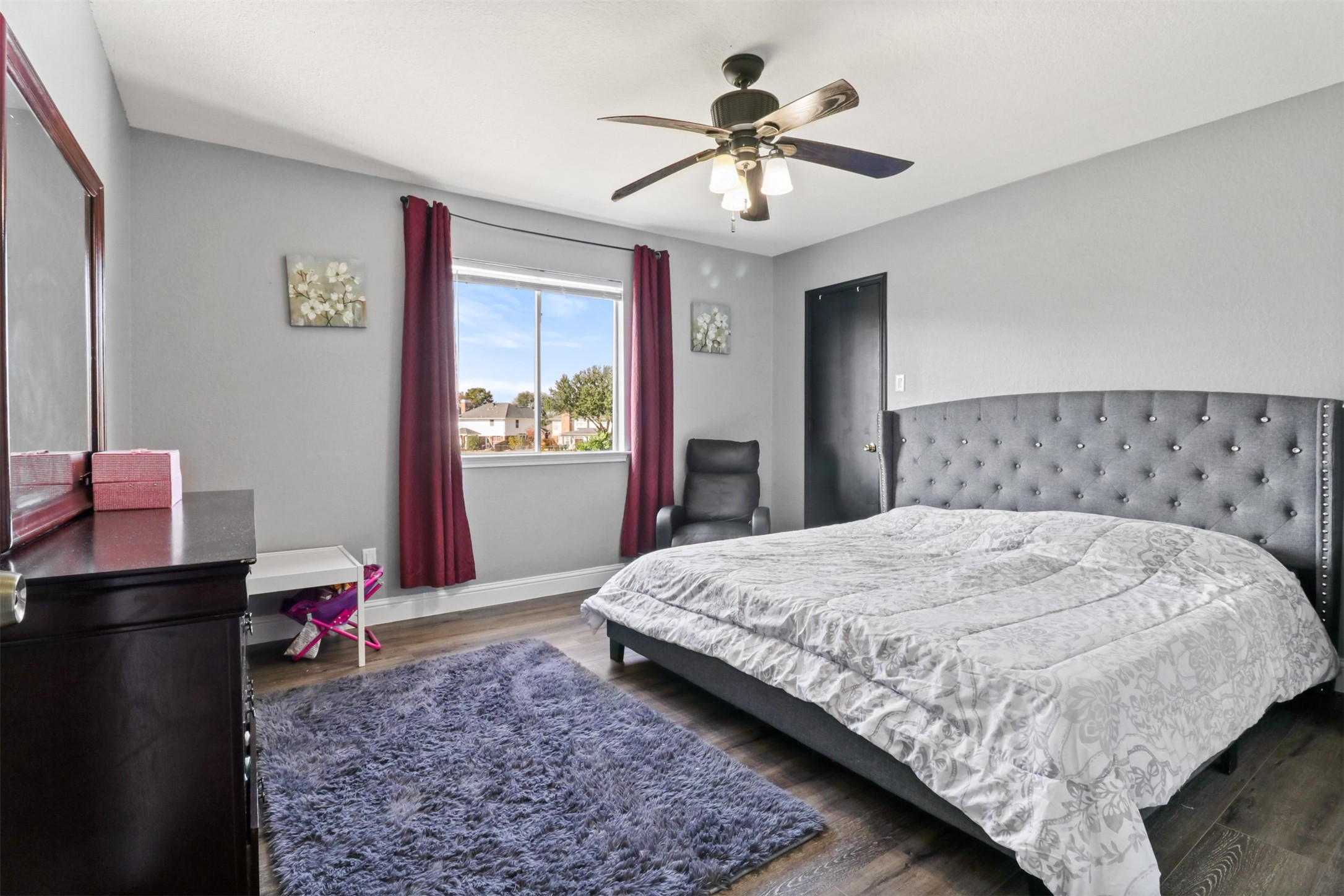 23027 Canal Road Richmond, TX 77406 - Photo 20 of 31 a bedroom with a large bed and a chandelier
