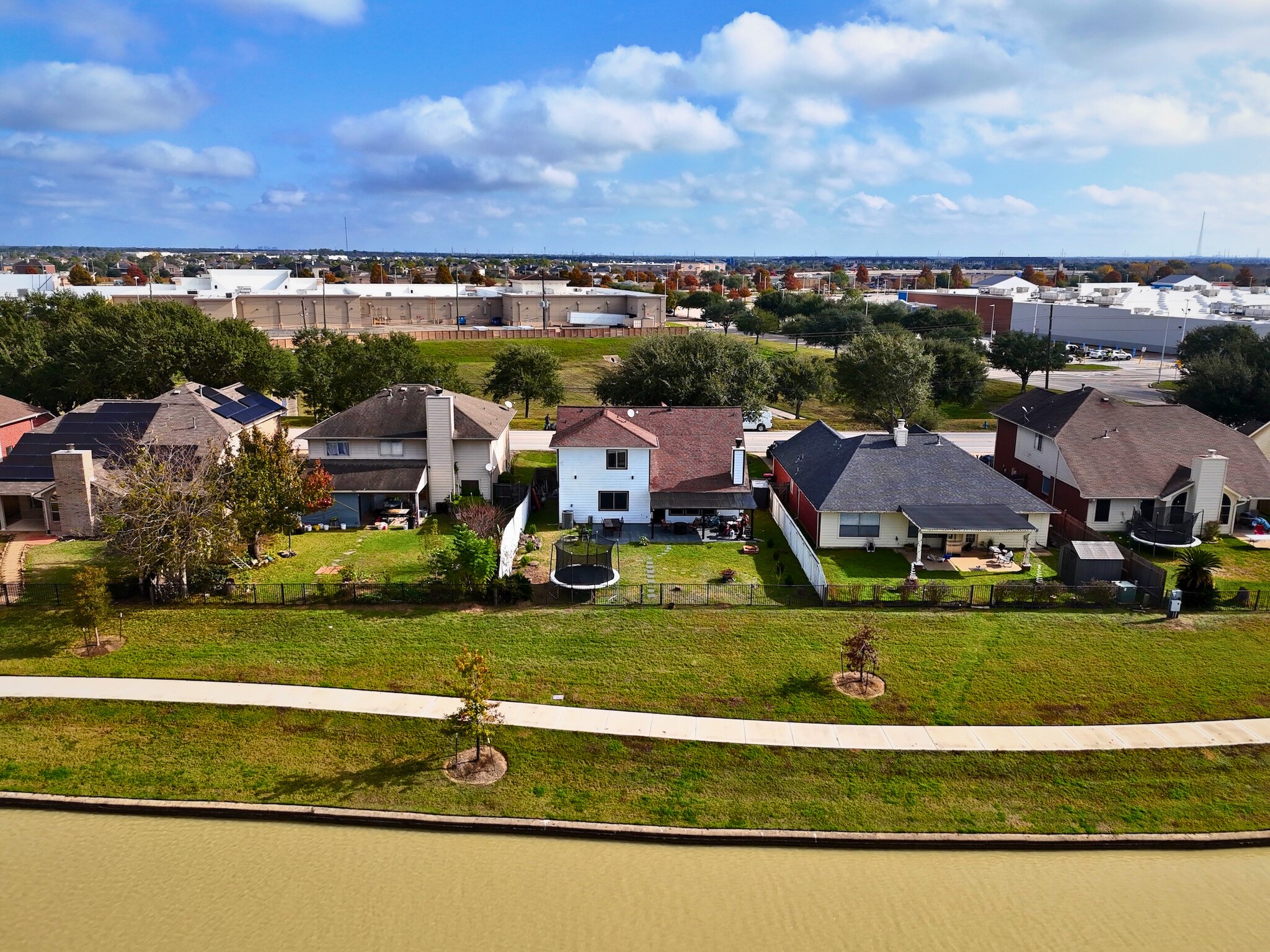23027 Canal Road Richmond, TX 77406 - Photo 26 of 31 an aerial view of residential houses with outdoor space and swimming pool