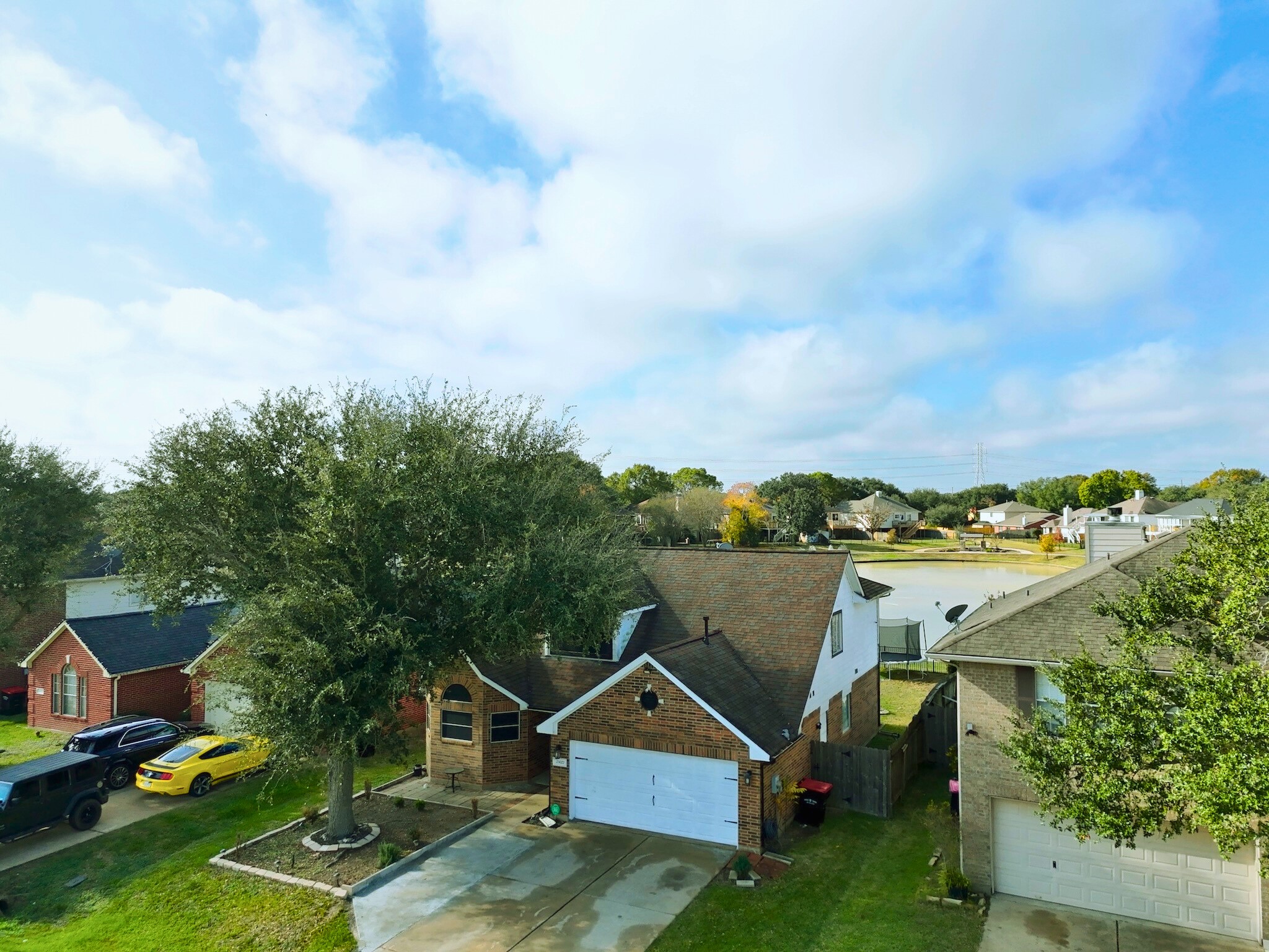 23027 Canal Road Richmond, TX 77406 - Photo 28 of 31 a view of a house with a big yard potted plants and large tree