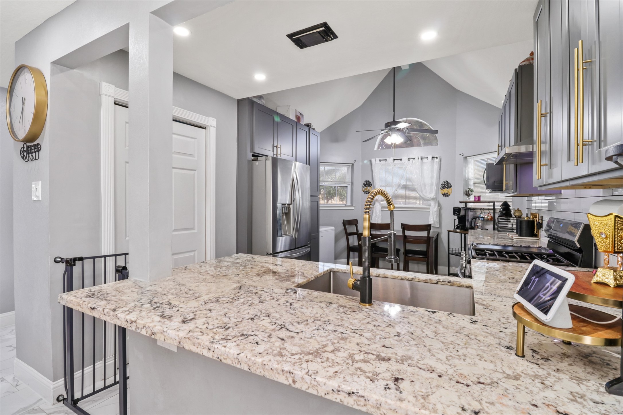 23027 Canal Road Richmond, TX 77406 - Photo 9 of 31 a kitchen with stainless steel appliances kitchen island granite countertop a refrigerator and a sink