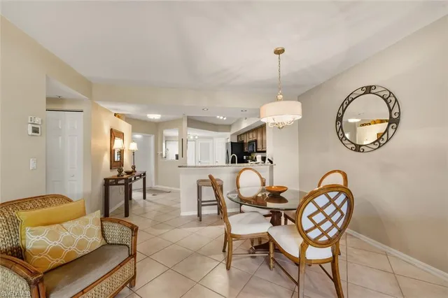 a living room with furniture a large window and wooden floor