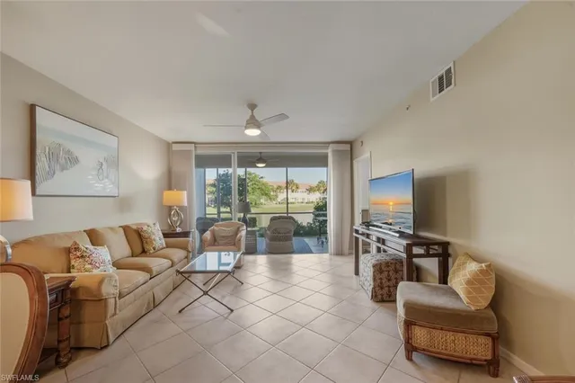 a living room with furniture a dining table and chairs