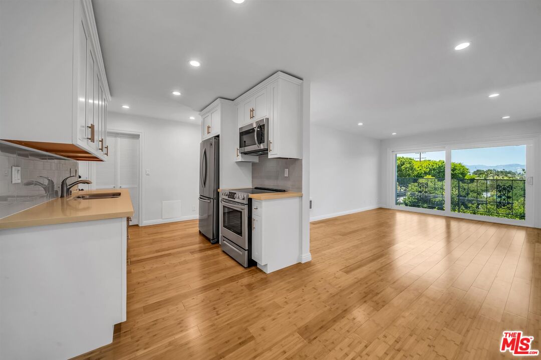 2901 4th Street Santa Monica, CA 90405 - Photo 5 of 6 a kitchen with stainless steel appliances a stove top oven a sink a counter space and cabinets