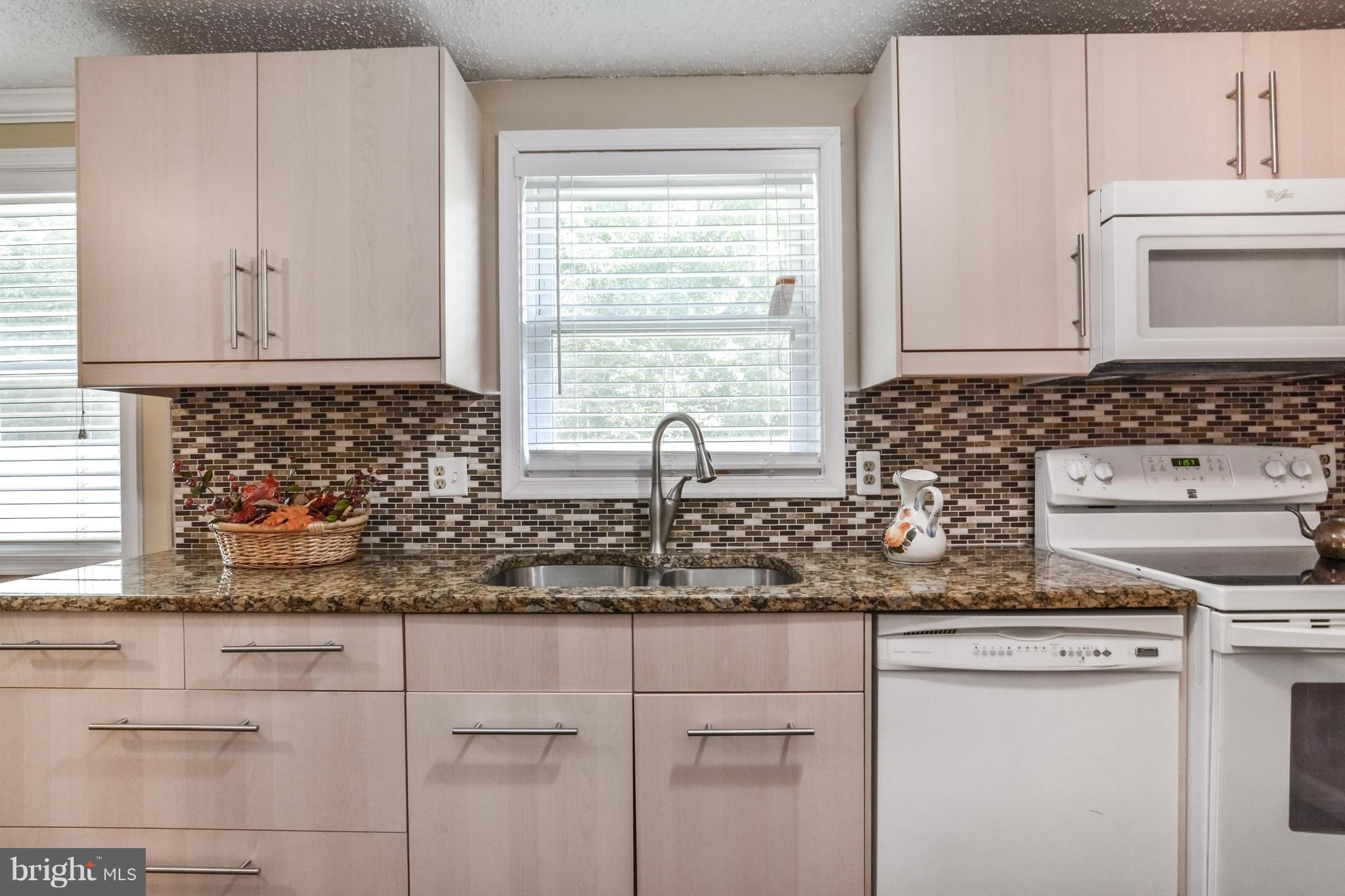 8609 Spring Creek Court Springfield, VA 22153 - Photo 2 of 30 a kitchen with stainless steel appliances white cabinets and a window