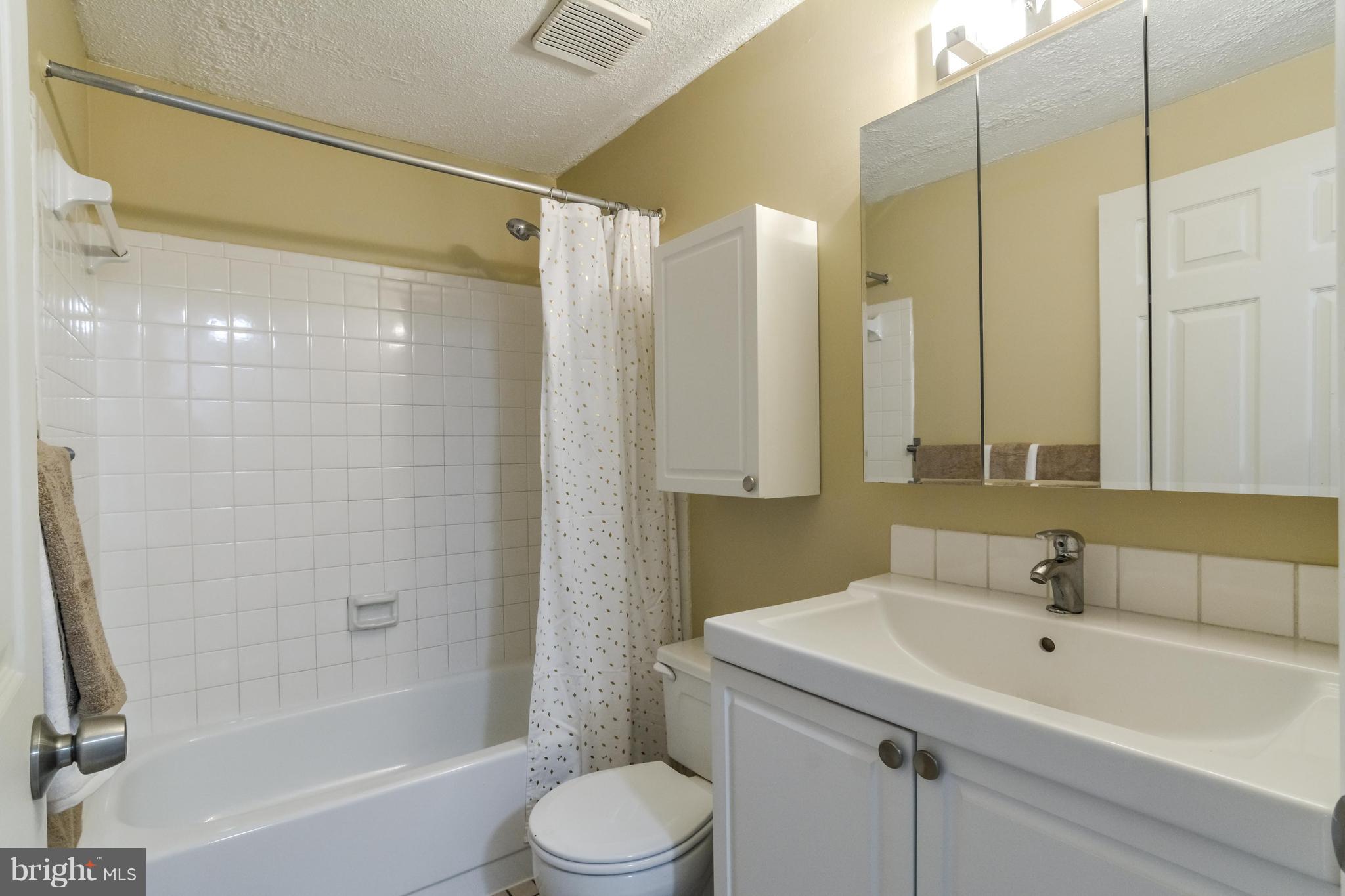 8609 Spring Creek Court Springfield, VA 22153 - Photo 15 of 30 a bathroom with a sink toilet and shower