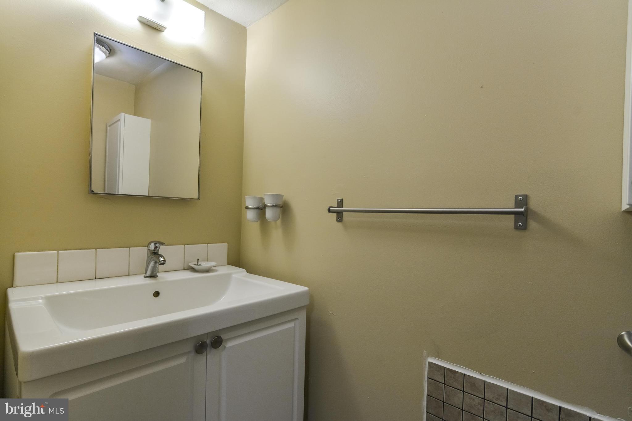 8609 Spring Creek Court Springfield, VA 22153 - Photo 21 of 30 a bathroom with a sink and a mirror