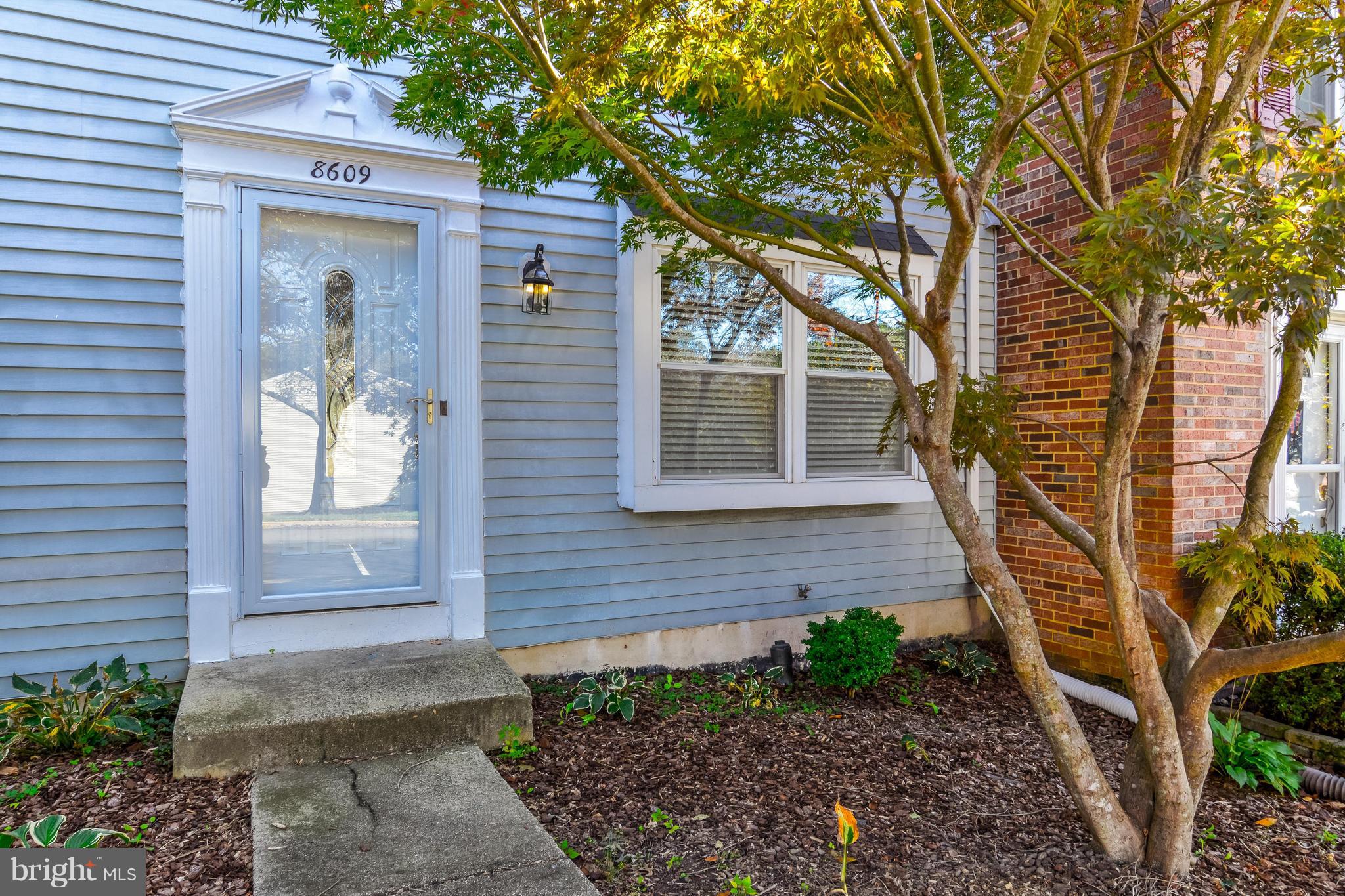 8609 Spring Creek Court Springfield, VA 22153 - Photo 24 of 30 a front view of a house with a tree