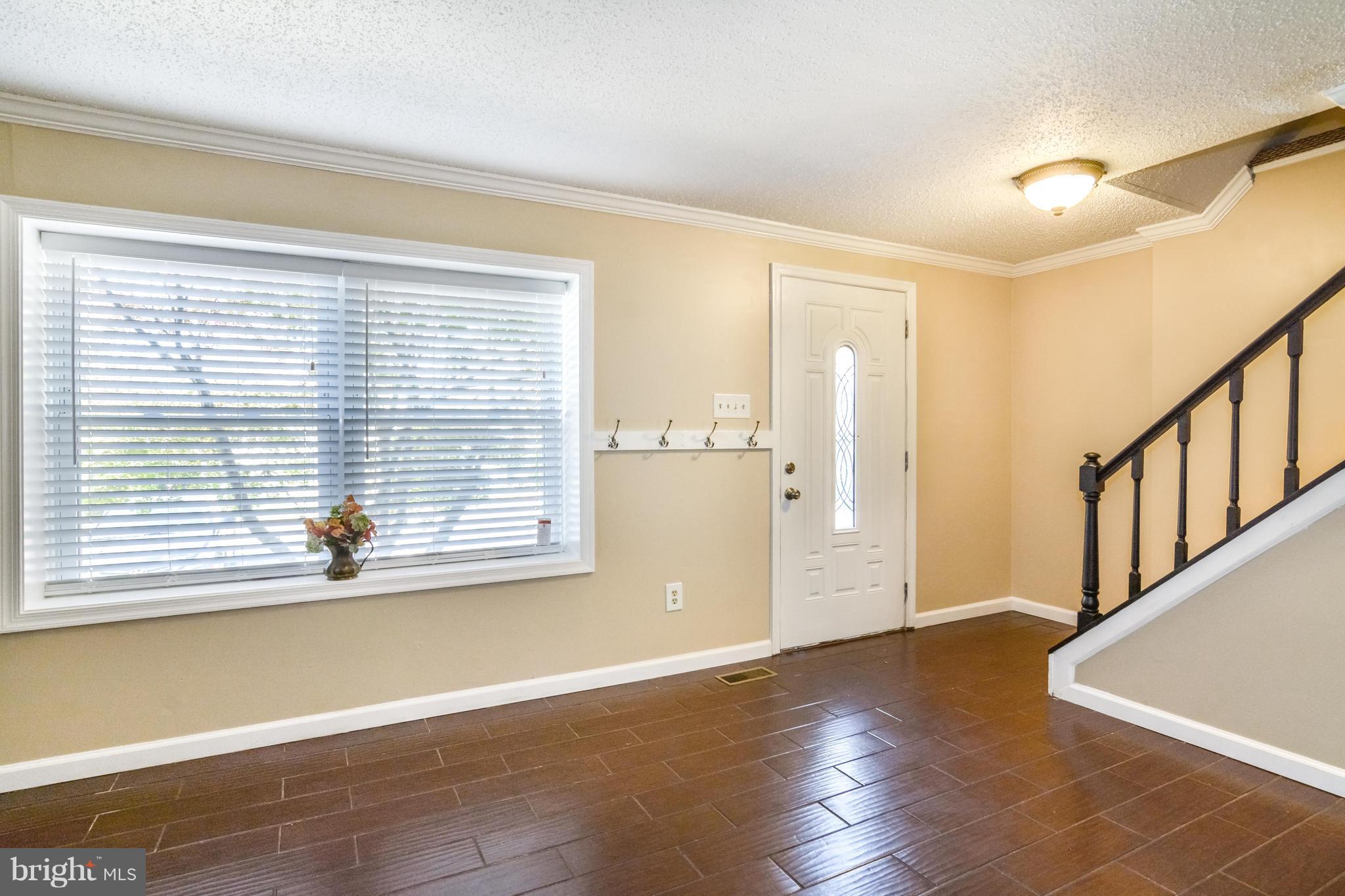 8609 Spring Creek Court Springfield, VA 22153 - Photo 25 of 30 a view of an empty room with wooden floor and a window