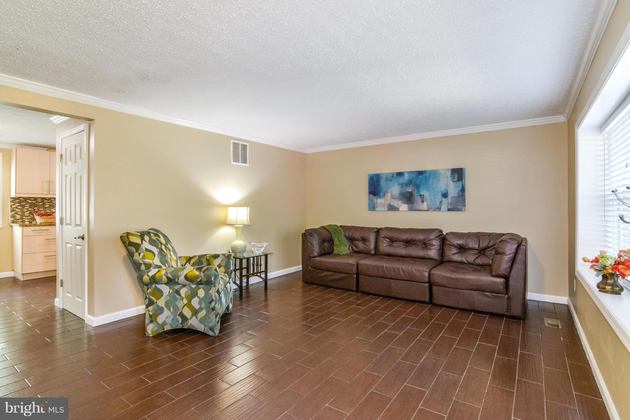 8609 Spring Creek Court Springfield, VA 22153 - Photo 26 of 30 a living room with furniture a couch and wooden floor