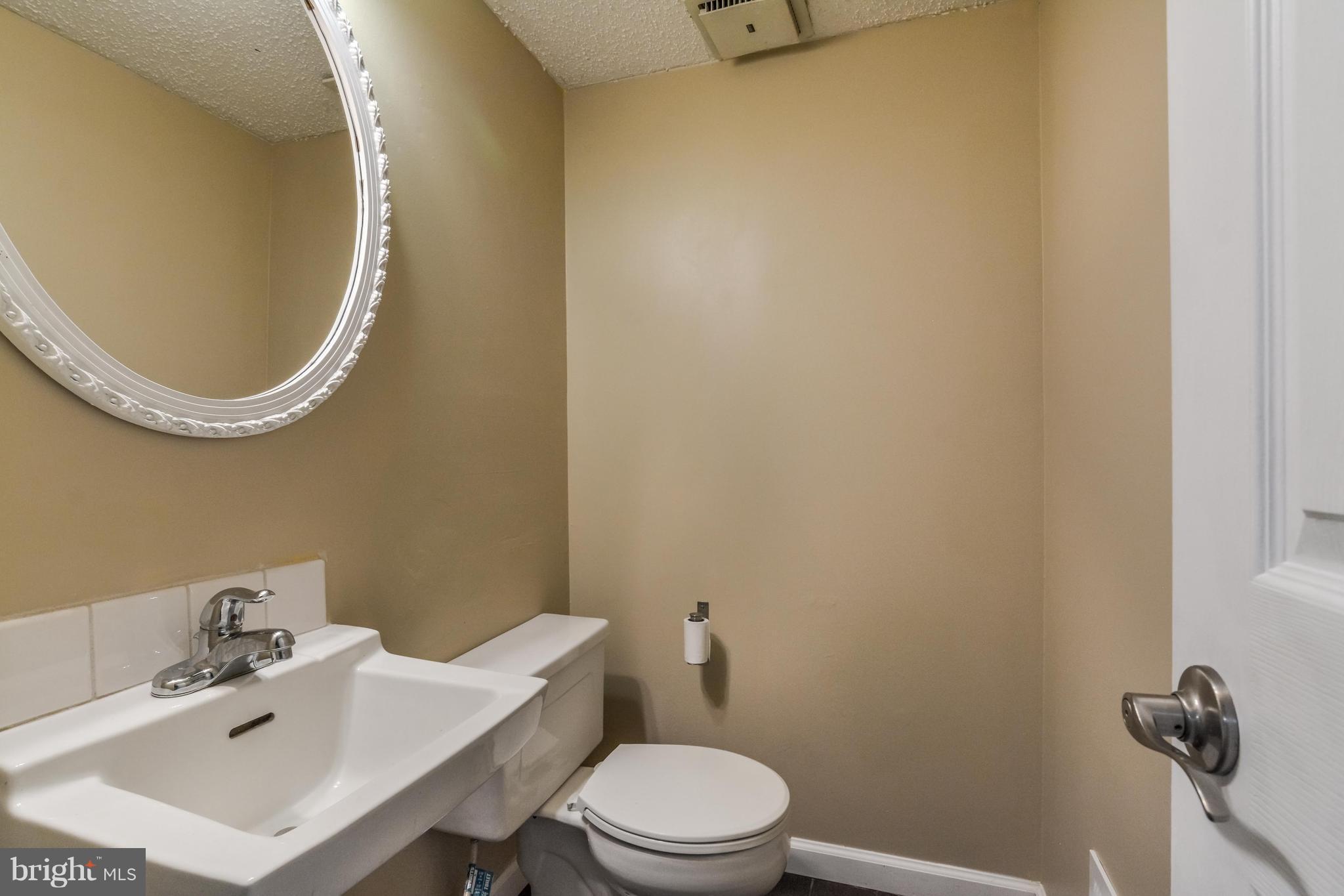 8609 Spring Creek Court Springfield, VA 22153 - Photo 5 of 30 a bathroom with a sink a toilet and a mirror