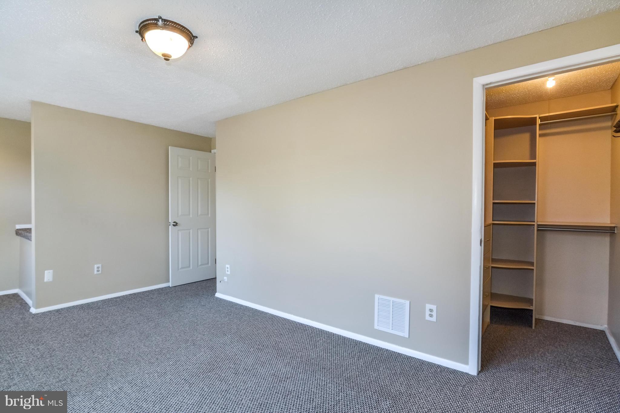 8609 Spring Creek Court Springfield, VA 22153 - Photo 9 of 30 an empty room with closet and windows