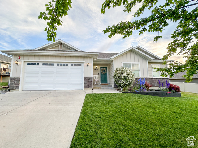 1439 Fox Crossing Elk Ridge, UT 84651 - Photo 1 of 1 View of front facade featuring a garage and a front yard