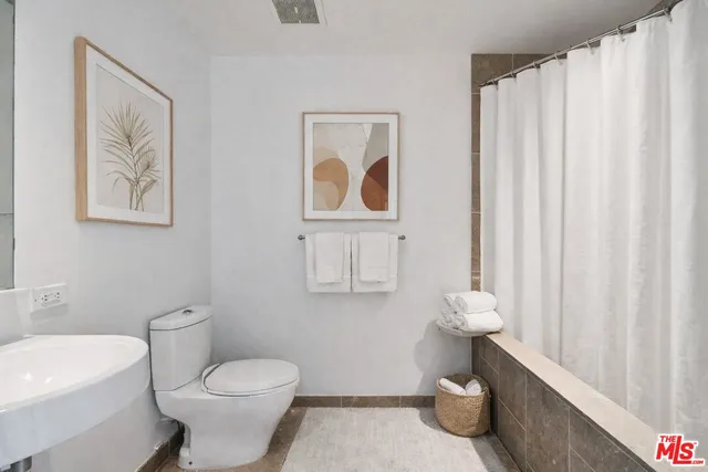 a bathroom with a toilet a sink and a shower