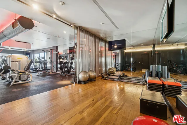 a view of a gym room with gym equipment
