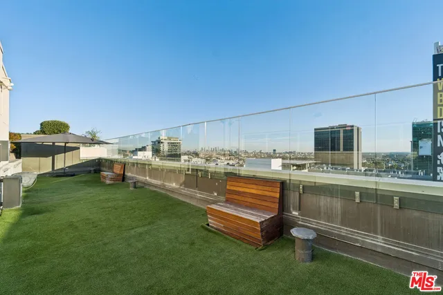 a view of a kitchen with a sink and sitting area