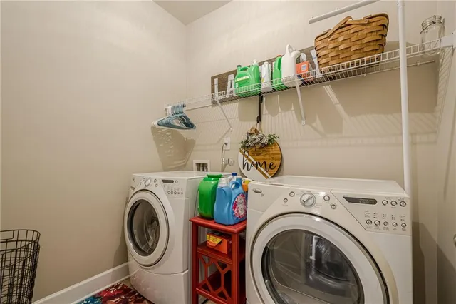 a large kitchen with a large counter top stainless steel appliances and cabinets