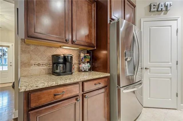 a kitchen with granite countertop stainless steel appliances a sink and cabinets