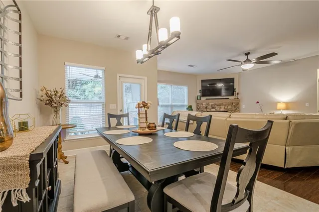 a kitchen with granite countertop a refrigerator and a stove top oven