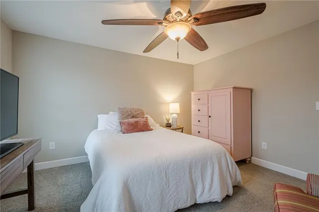 a bedroom with a bed and a desk