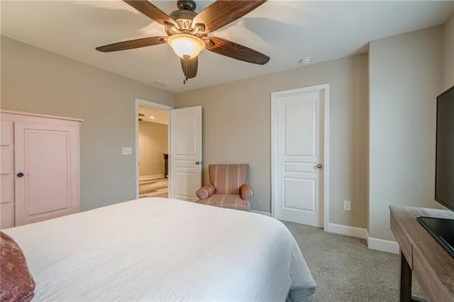 a bedroom with furniture and a flat screen tv