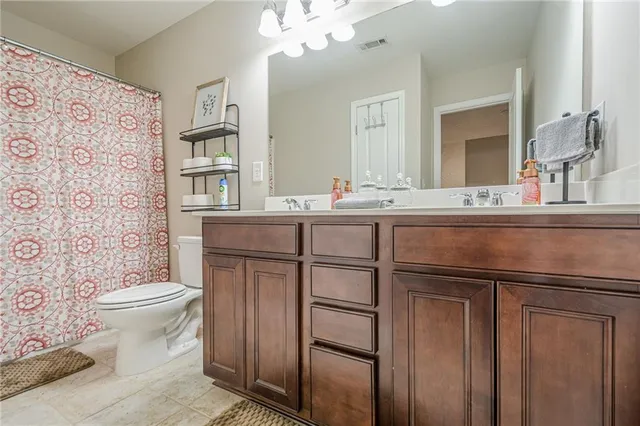 a view of a house with a big yard and large trees