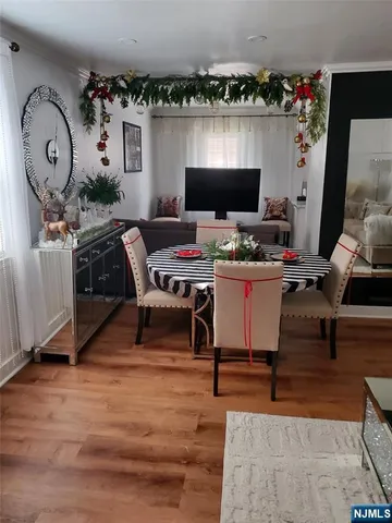 a view of a workspace with furniture and a flat screen tv